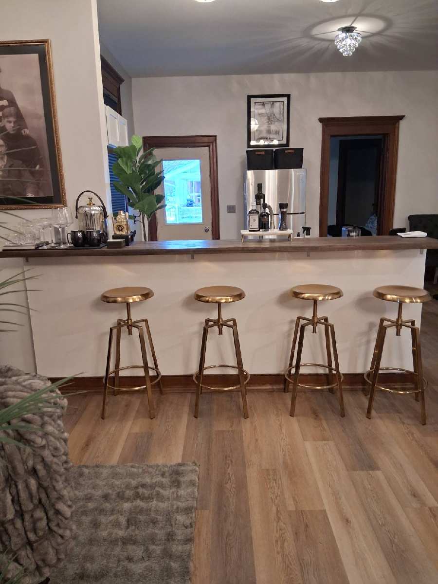 Bar area with gold stools and wood countertop